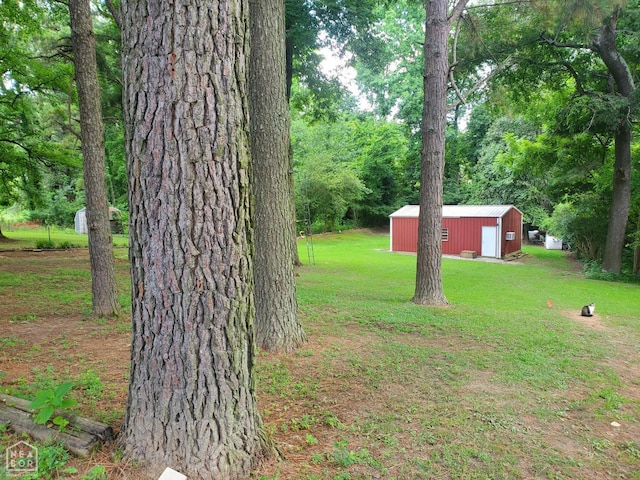 691 Crestline Dr, Piggott, AR 72454 - view of green lawn with an outdoor structure, an outbuilding, and a detached garage