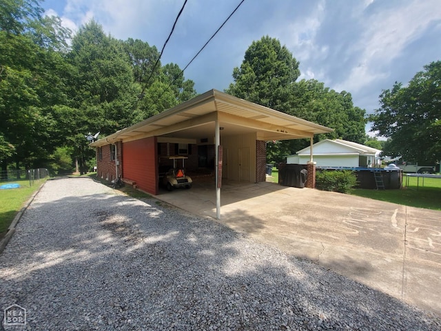 691 Crestline Dr, Piggott, AR 72454 - view of vehicle parking featuring gravel driveway and a carport