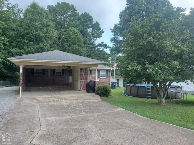 691 Crestline Dr, Piggott, AR 72454 - view of front of home featuring driveway, a front yard, a carport, an outdoor pool, and brick siding