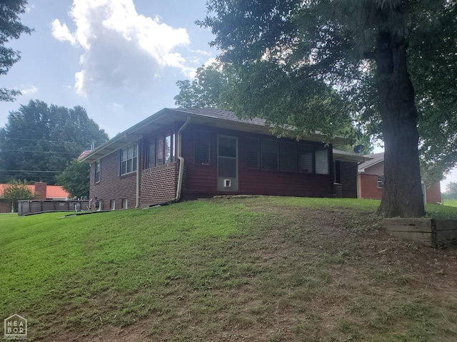 691 Crestline Dr, Piggott, AR 72454 - rear view of property featuring a lawn