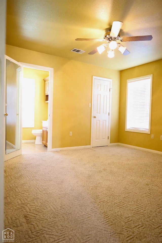spare room featuring a ceiling fan, baseboards, and carpet floors