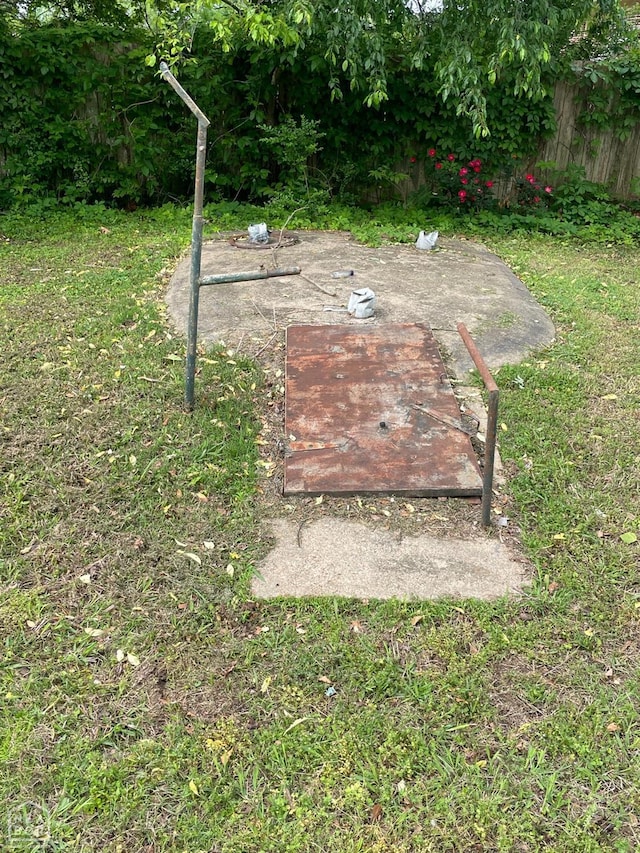 view of storm shelter featuring fence and a yard