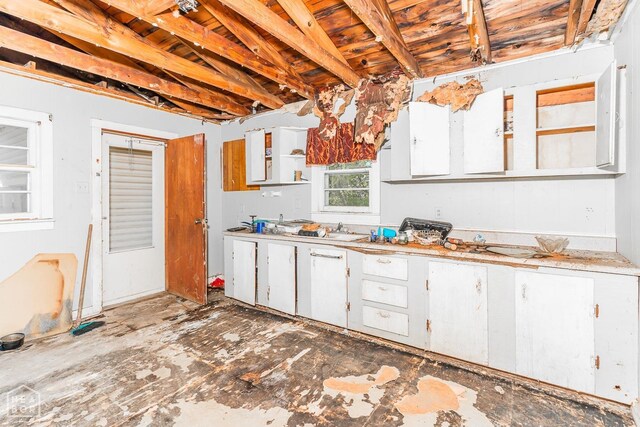kitchen featuring white cabinets, light countertops, and open shelves