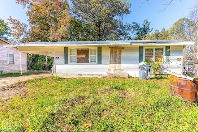 view of front of house featuring an attached carport and concrete driveway