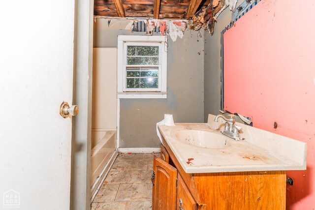 full bathroom featuring vanity and a tub