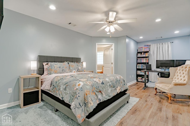 1409 Hemingway Cir, Jonesboro, AR 72405 - bedroom featuring baseboards, wood finished floors, recessed lighting, ceiling fan, and connected bathroom