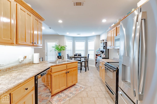 1409 Hemingway Cir, Jonesboro, AR 72405 - kitchen with black appliances, a sink, light brown cabinets, light countertops, and recessed lighting