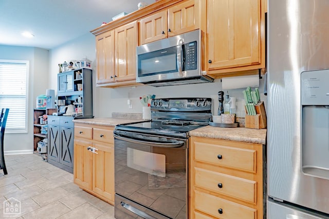1409 Hemingway Cir, Jonesboro, AR 72405 - kitchen featuring appliances with stainless steel finishes, light brown cabinetry, and light countertops