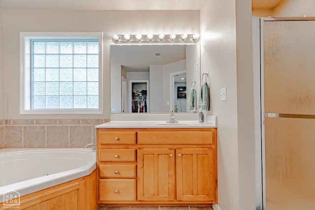1409 Hemingway Cir, Jonesboro, AR 72405 - bathroom featuring a shower stall, plenty of natural light, vanity, and a bath