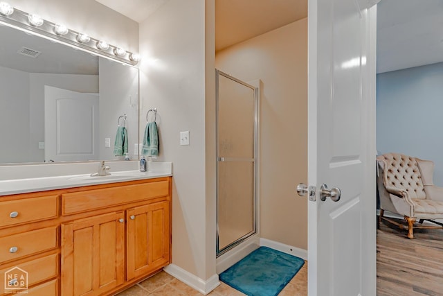 1409 Hemingway Cir, Jonesboro, AR 72405 - bathroom featuring vanity, a shower stall, baseboards, and tile patterned flooring