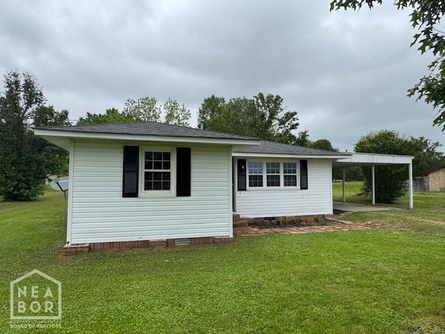 330 E Oak St E, Bono, AR 72416 - view of front facade with a carport, crawl space, and a front lawn