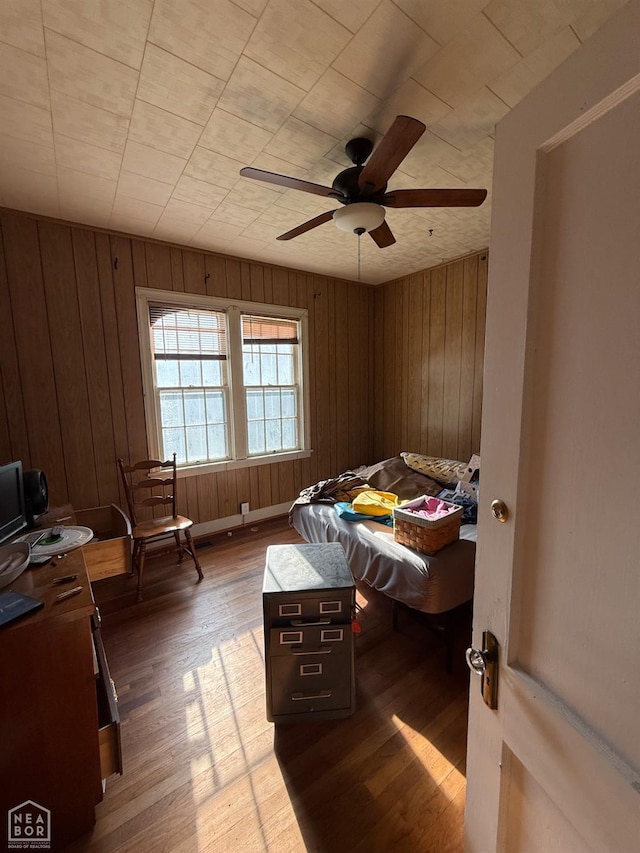 420 W Cherry Ave W, Jonesboro, AR 72401 - bedroom featuring wood finished floors, wood walls, and ceiling fan