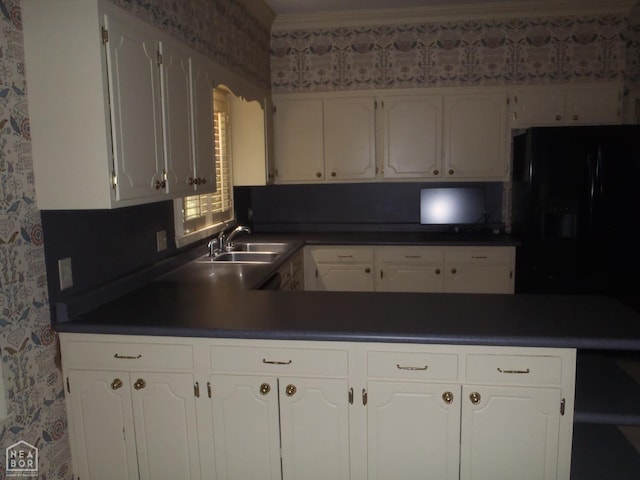 4 Virginia Rd, Newport, AR 72112 - kitchen featuring dark countertops, a peninsula, white cabinetry, wallpapered walls, and freestanding refrigerator