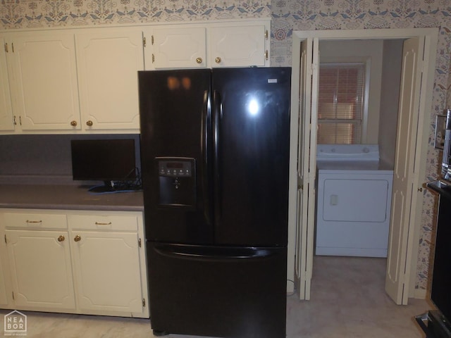 4 Virginia Rd, Newport, AR 72112 - kitchen with black refrigerator with ice dispenser, washer / clothes dryer, wallpapered walls, white cabinets, and dark countertops