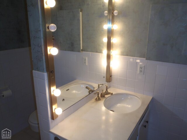 4 Virginia Rd, Newport, AR 72112 - bathroom featuring tile walls, vanity, a wainscoted wall, and wallpapered walls