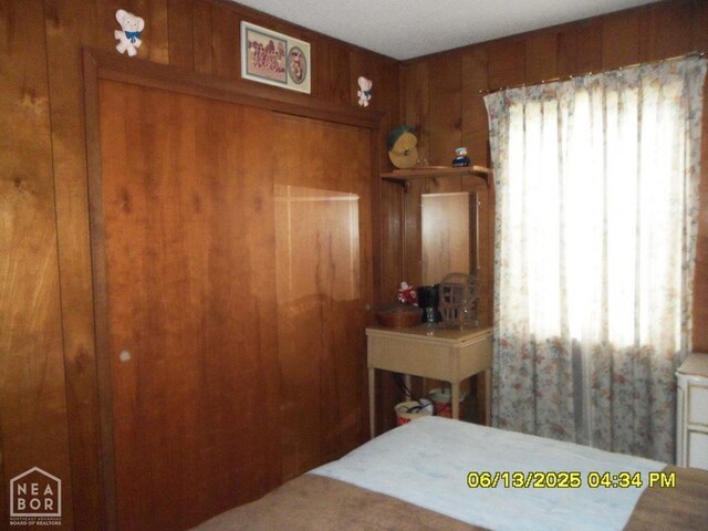 2805 Robinson St, Newport, AR 72112 - carpeted bedroom with wooden walls