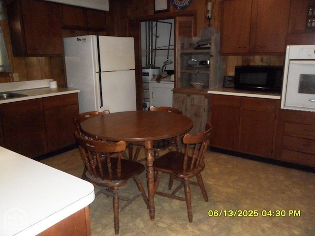 2805 Robinson St, Newport, AR 72112 - kitchen featuring white appliances, light floors, light countertops, and wooden walls