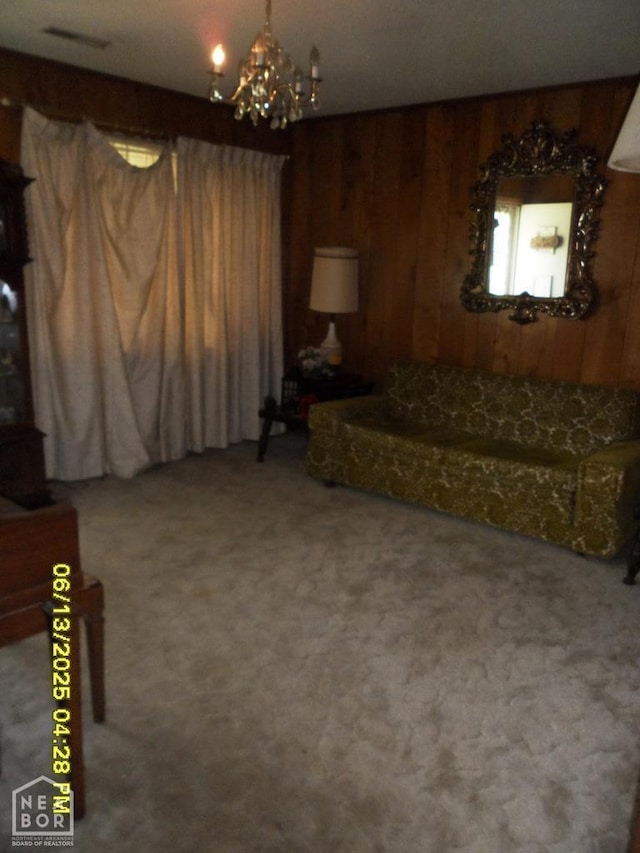 2805 Robinson St, Newport, AR 72112 - carpeted living room featuring wood walls and a chandelier