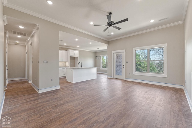 unfurnished living room with baseboards, ceiling fan, visible vents, and dark wood-style floors