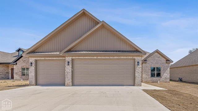 view of front of property featuring concrete driveway, brick siding, and board and batten siding