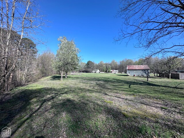 245 S 18th St, Piggott, AR 72454 - view of snowy exterior featuring a carport and brick siding