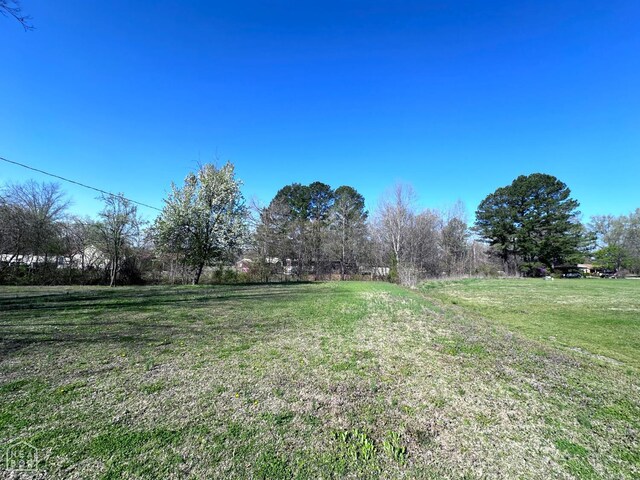 245 S 18th St, Piggott, AR 72454 - view of front of house featuring crawl space, an outbuilding, and a storage unit