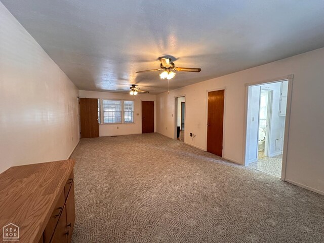 245 S 18th St, Piggott, AR 72454 - unfurnished living room featuring carpet floors and ceiling fan