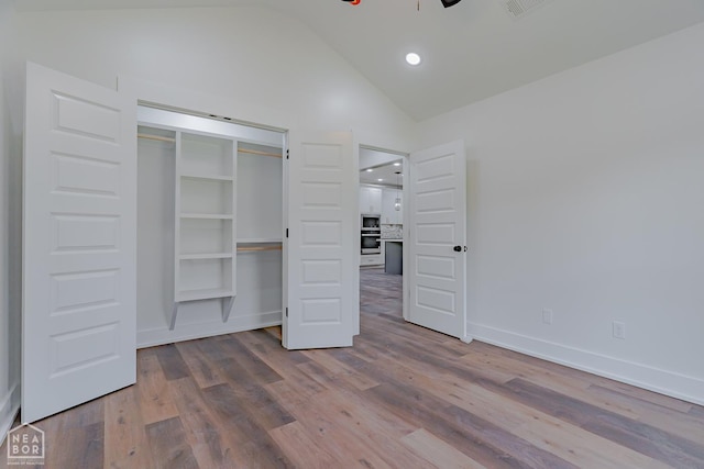400 Gia St, Bono, AR 72416 - unfurnished bedroom with vaulted ceiling, wood finished floors, a closet, and recessed lighting