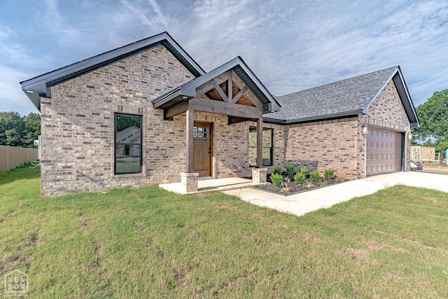 400 Gia St, Bono, AR 72416 - view of front facade featuring brick siding, concrete driveway, an attached garage, and a shingled roof