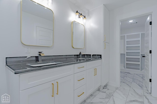400 Gia St, Bono, AR 72416 - full bathroom with marble finish flooring, double vanity, a walk in closet, and recessed lighting