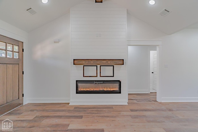 400 Gia St, Bono, AR 72416 - entryway featuring vaulted ceiling, a fireplace, recessed lighting, and light wood-style floors