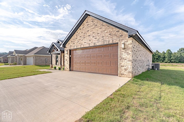 400 Gia St, Bono, AR 72416 - view of home's exterior featuring a lawn, concrete driveway, a garage, and brick siding