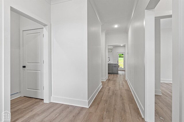3424 Hudson Dr, Jonesboro, AR 72405 - hallway with baseboards, light wood-type flooring, and crown molding