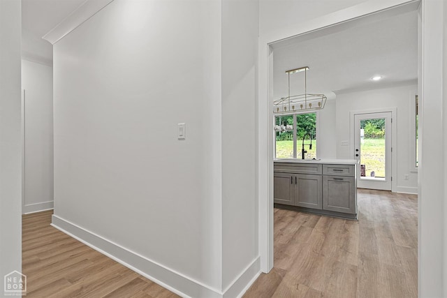 3424 Hudson Dr, Jonesboro, AR 72405 - corridor featuring light wood-style flooring, a sink, and baseboards