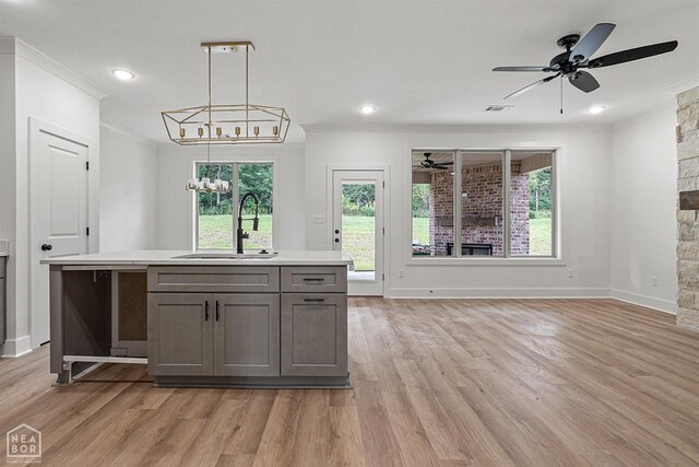 3424 Hudson Dr, Jonesboro, AR 72405 - kitchen featuring crown molding, ceiling fan with notable chandelier, gray cabinets, a sink, and light countertops