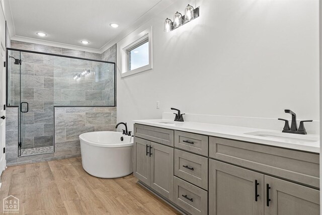 3424 Hudson Dr, Jonesboro, AR 72405 - full bath featuring a sink, a shower stall, a soaking tub, and wood finished floors
