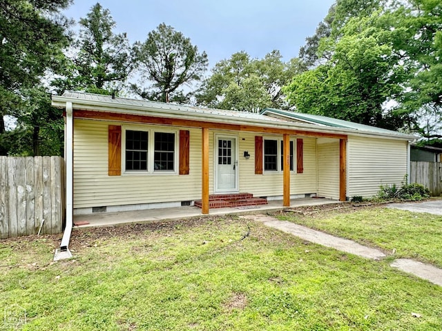 view of front of house featuring fence, metal roof, covered porch, crawl space, and a front lawn