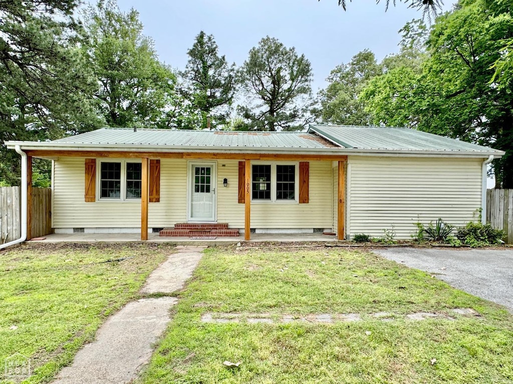 view of front of house with a front yard, fence, and crawl space