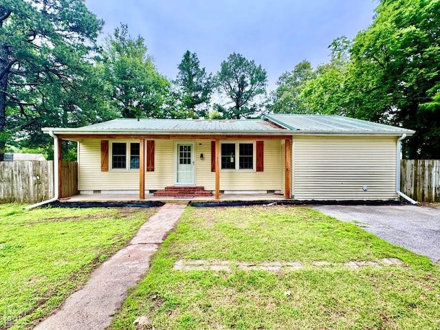 1005 W Lake St, Manila, AR 72442 - ranch-style home featuring crawl space, metal roof, and asphalt driveway
