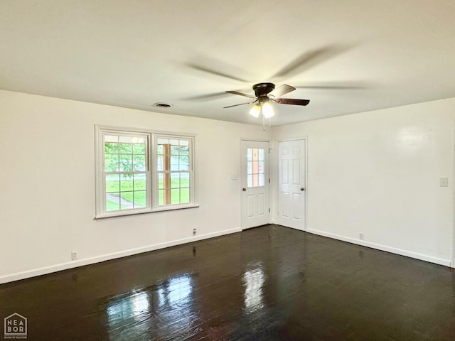 1005 W Lake St, Manila, AR 72442 - unfurnished room with a ceiling fan, baseboards, and dark wood finished floors