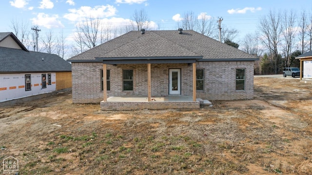 1816 N Oak, Brookland, AR 72417 - back of property featuring brick siding, a patio, and roof with shingles