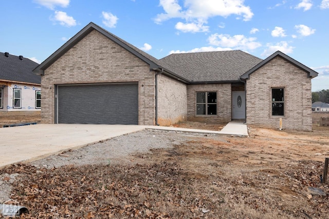 1816 N Oak, Brookland, AR 72417 - view of front of property with driveway, an attached garage, and brick siding