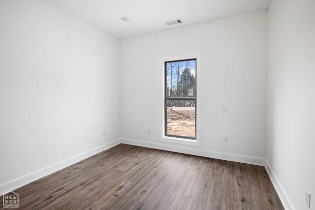 1816 N Oak, Brookland, AR 72417 - empty room featuring dark wood-style flooring and baseboards
