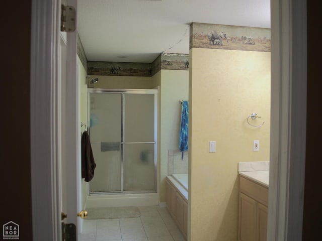 3300 Jeridon Cv, Jonesboro, AR 72404 - bathroom featuring a stall shower, vanity, tile patterned flooring, and a garden tub