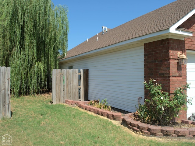 3300 Jeridon Cv, Jonesboro, AR 72404 - view of side of home featuring a garage, roof with shingles, and brick siding