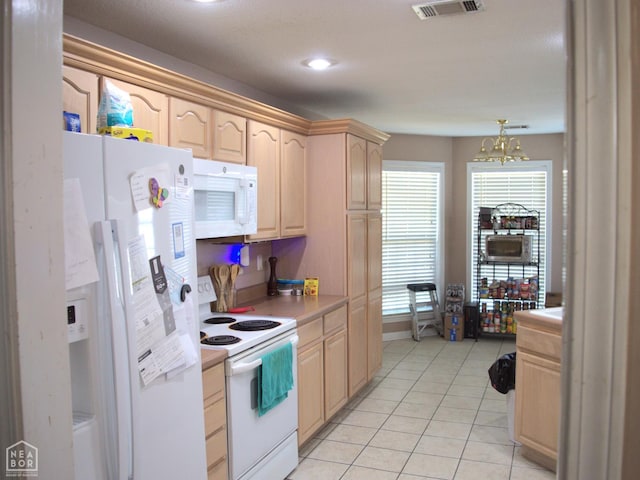 3300 Jeridon Cv, Jonesboro, AR 72404 - kitchen with white appliances, light brown cabinetry, light countertops, light tile patterned floors, and a chandelier