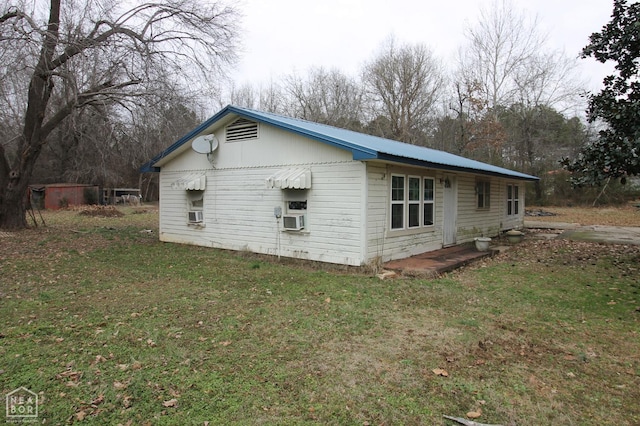261 Greene Road 507, Lafe, AR 72436 - view of side of home featuring a yard, cooling unit, and metal roof