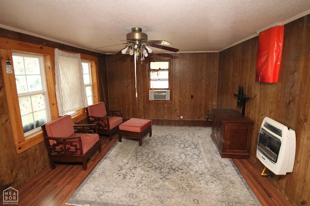 261 Greene Road 507, Lafe, AR 72436 - sitting room with heating unit, wood finished floors, a textured ceiling, a ceiling fan, and crown molding