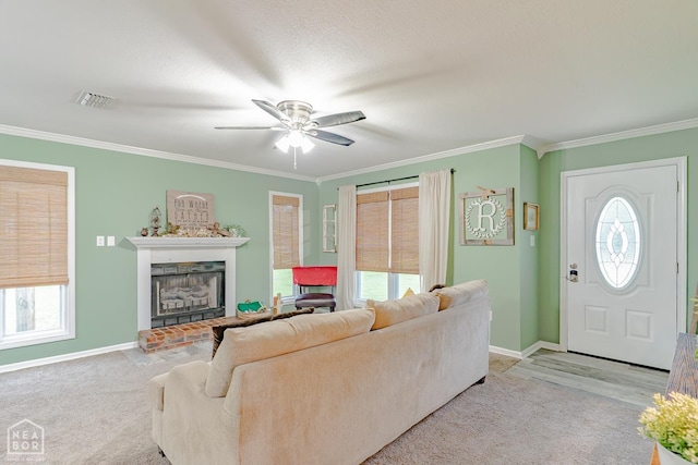 13326 Dixie Ln, Trumann, AR 72472 - living room with ornamental molding, a fireplace, ceiling fan, and carpet