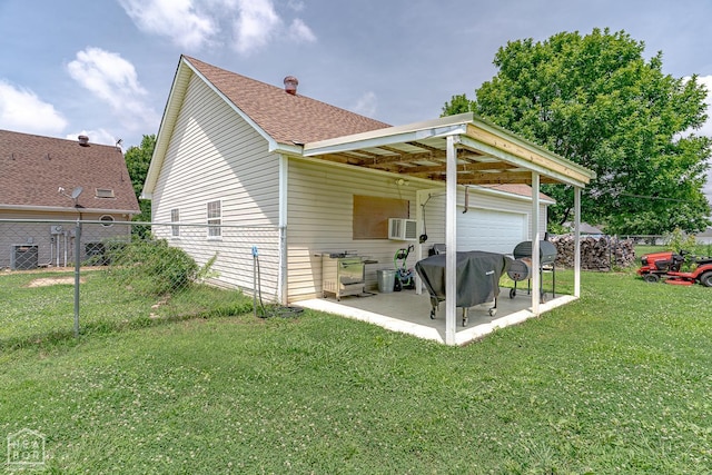 13326 Dixie Ln, Trumann, AR 72472 - back of house with a garage, roof with shingles, and a patio